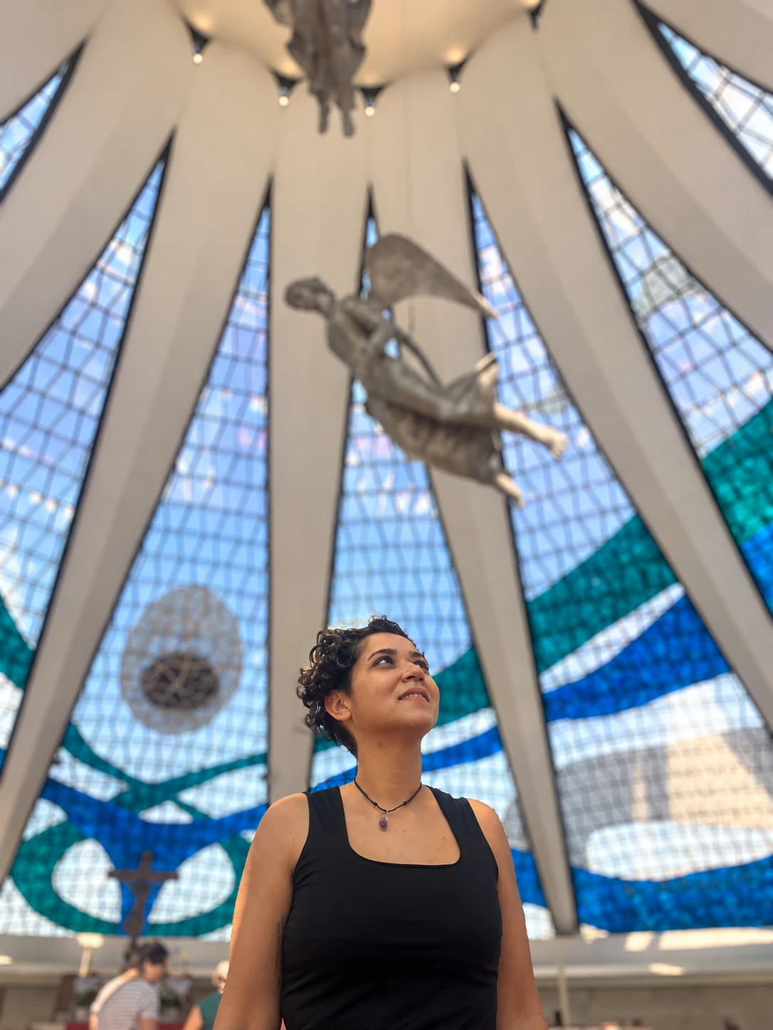 Tainara Santos na Catedral de Brasília, olhando para os vitrais
